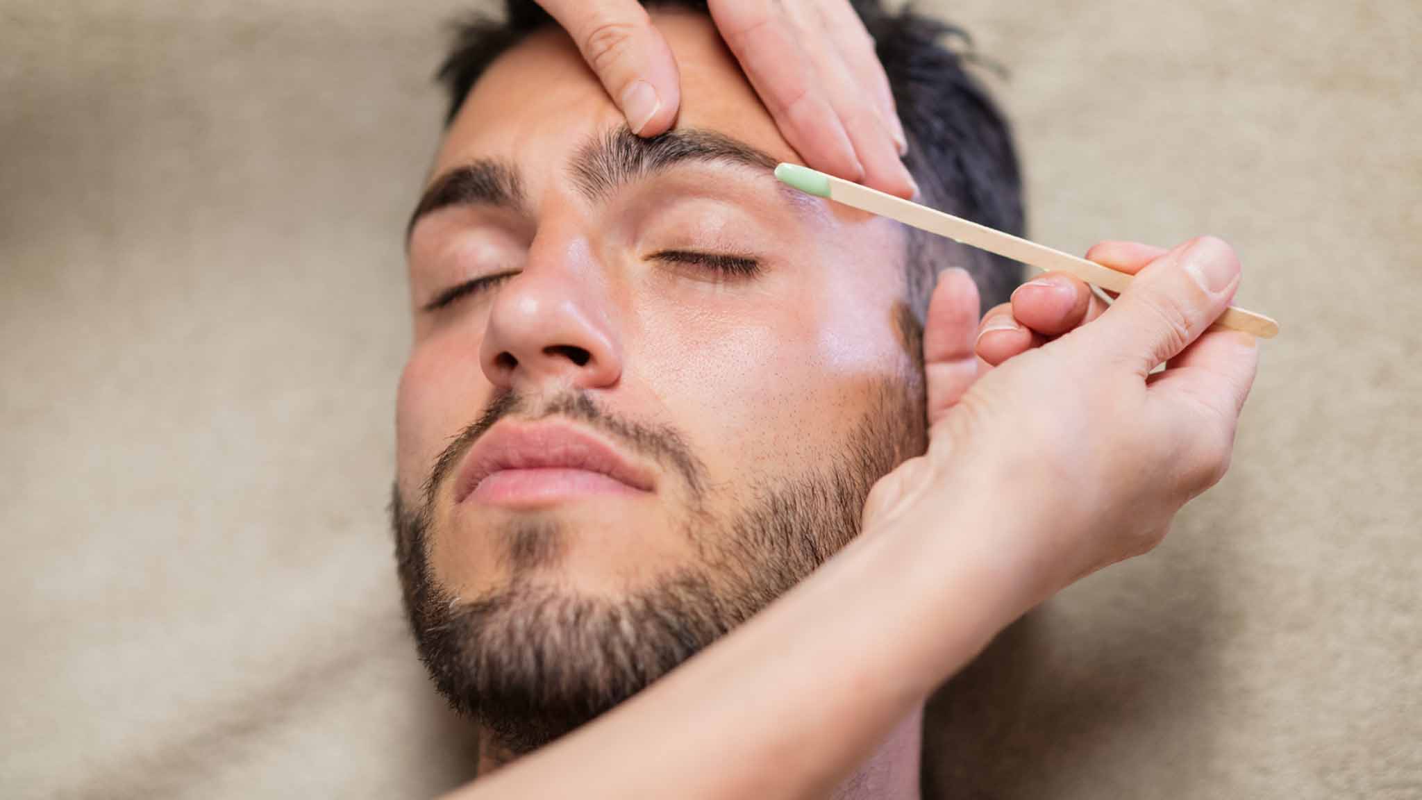 image of a man receiving eyebrow waxing services at aveda institute portland