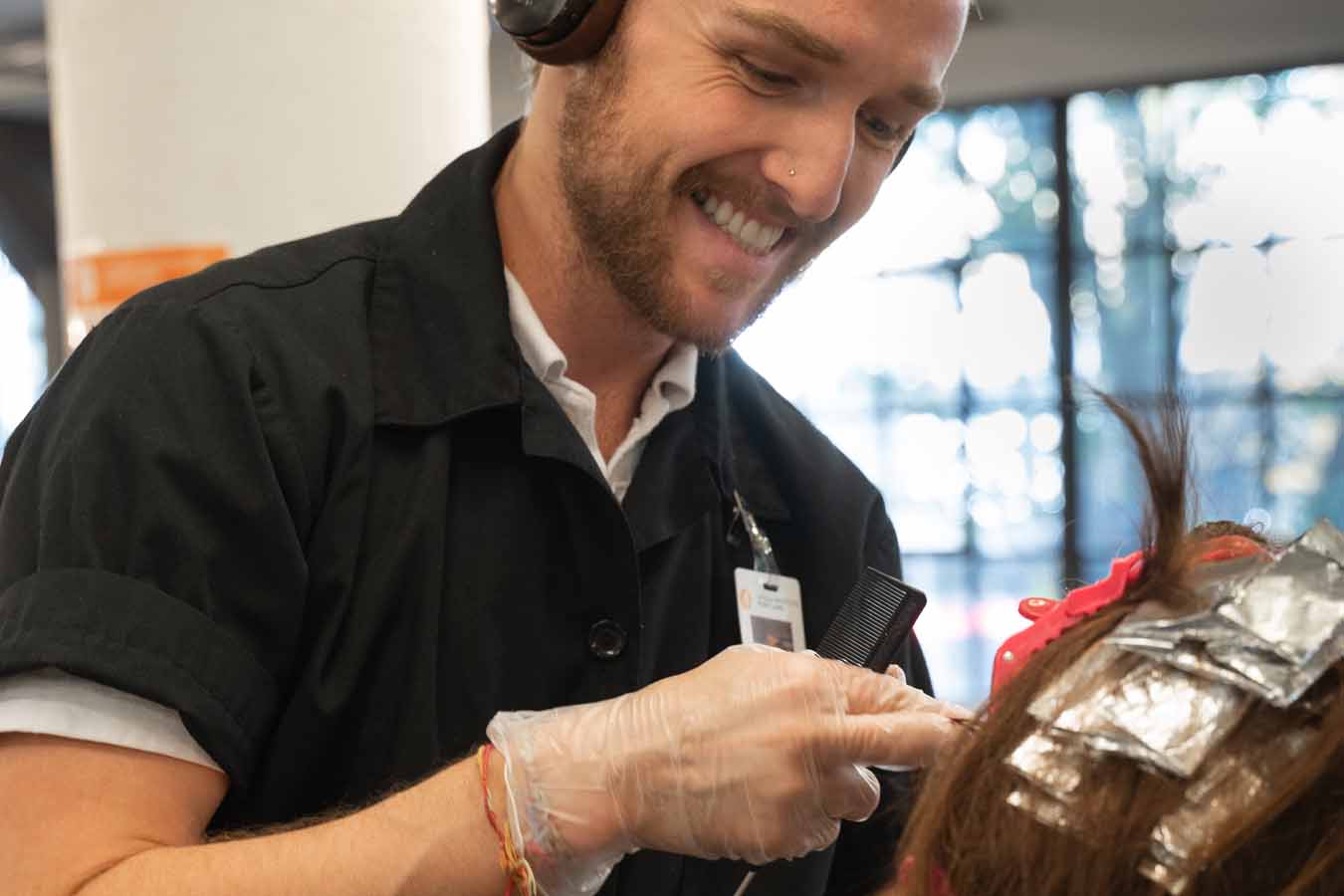 Image of a student applying color at aveda institute portland