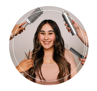 image of a student at aveda institute portland surrounded by products and tools used in the hair design program