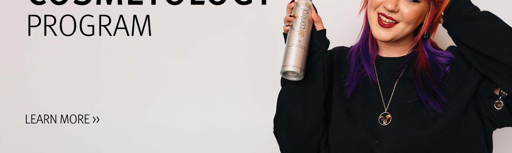 image of a student holding a can of air control hairspray in the Cosmetology program