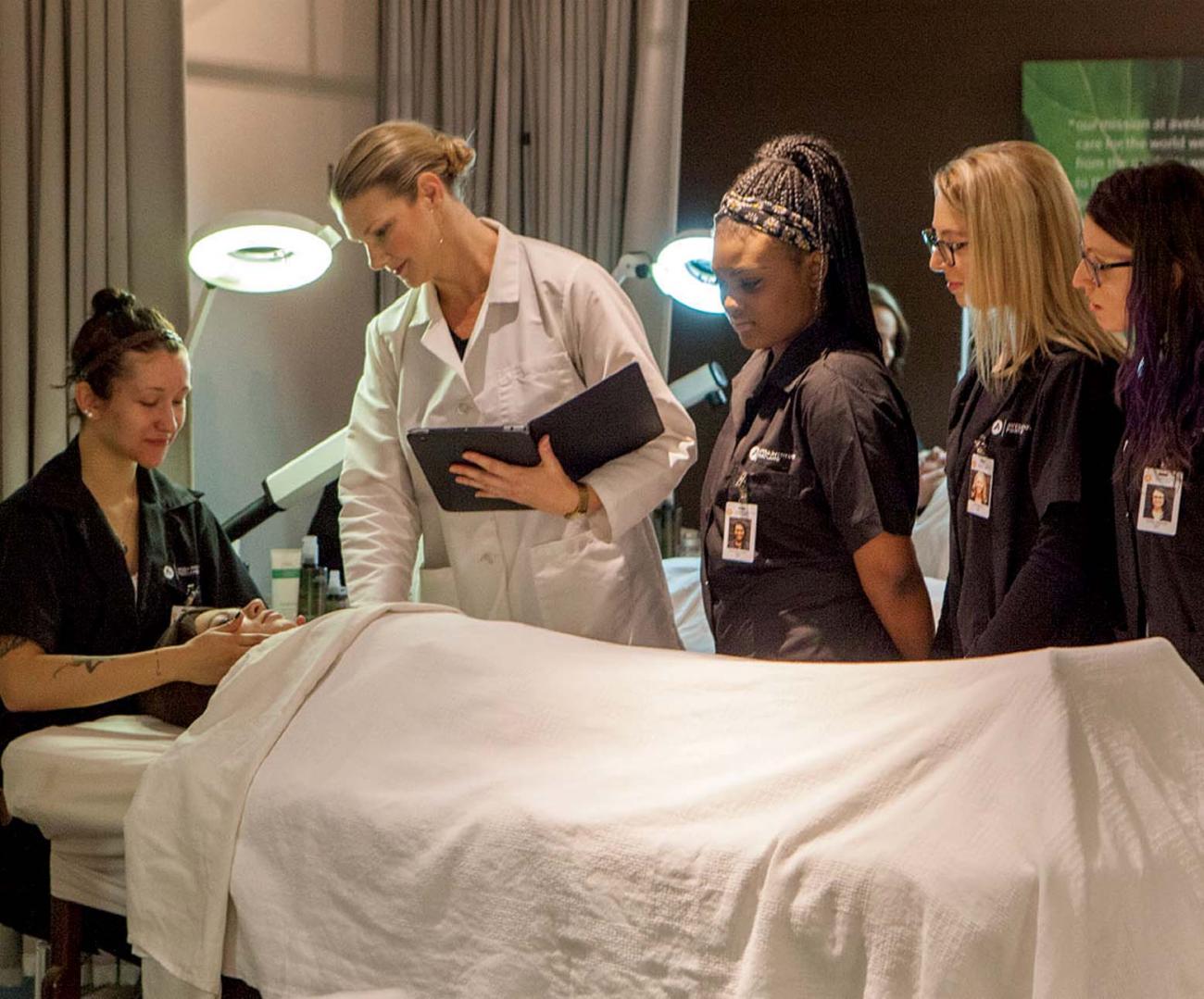 image of an esthi instructor teaching students with hands on experience