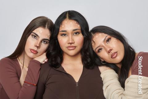 Image of a student photoshoot with three female models all dressed in neutral brown and tan colors. Their makeup is delicately done as reindeers